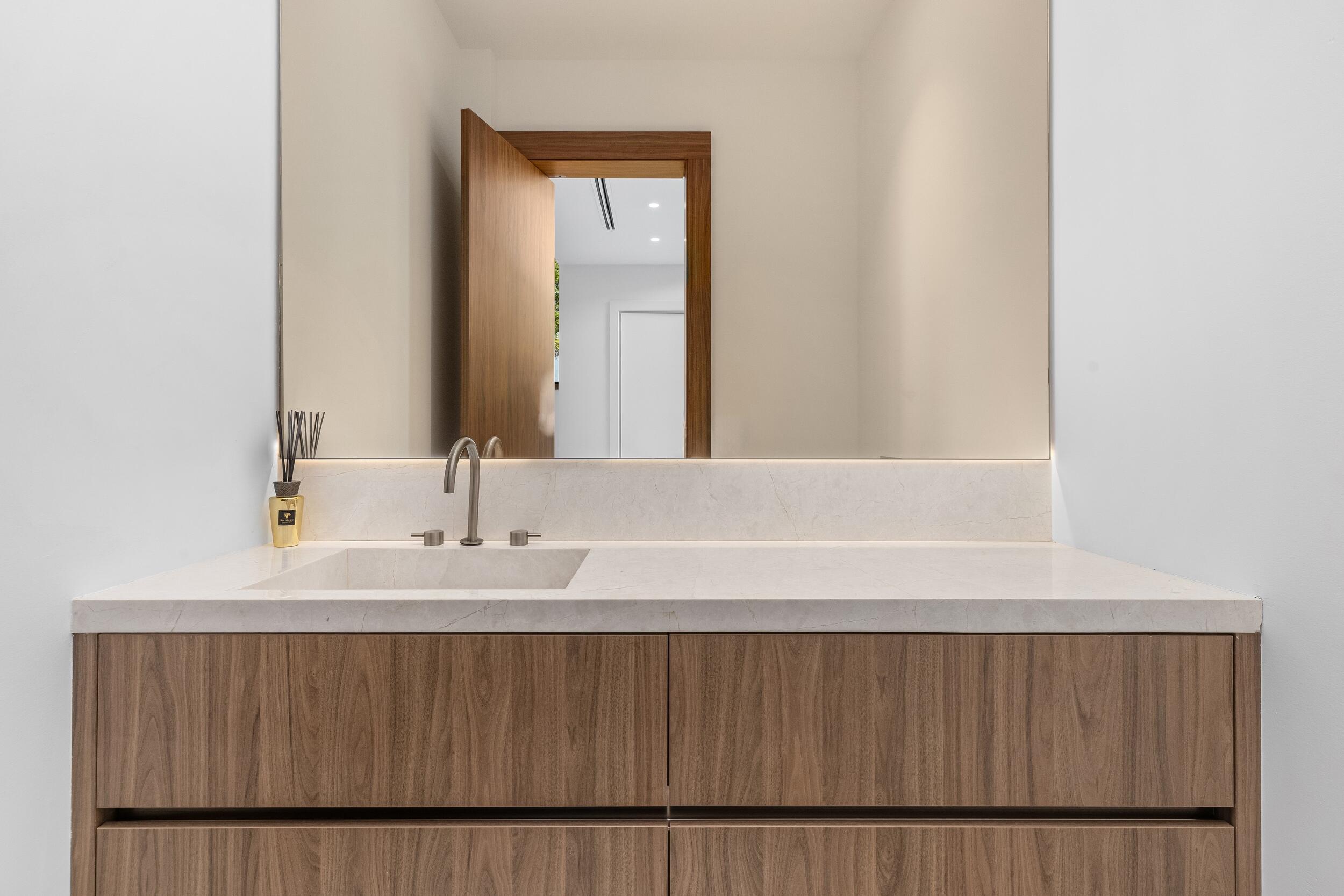 1099 Northeast 4th Avenue Boca Raton, FL 33432 - Photo 51 of 60 a bathroom with a sink a mirror and a vanity