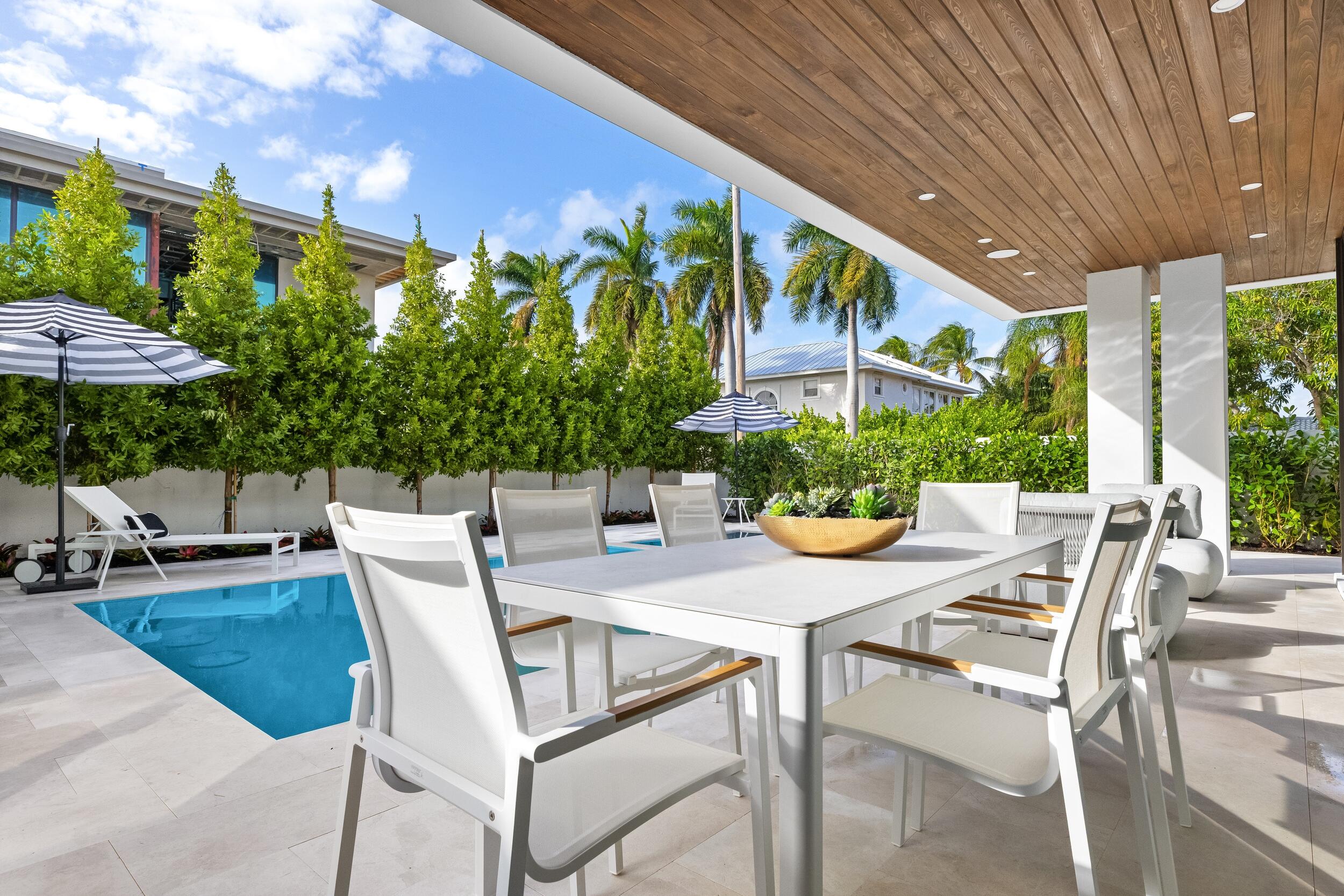 1099 Northeast 4th Avenue Boca Raton, FL 33432 - Photo 54 of 60 a view of an outdoor dining space with a table and chairs