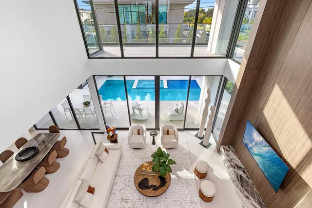 a living room with furniture and large windows