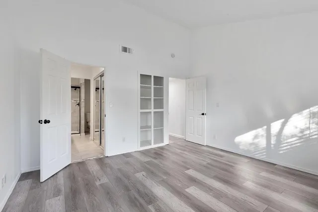 a view of empty room with wooden floor