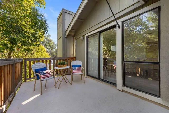 a balcony with chairs and a table