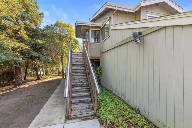 a view of a house with wooden fence