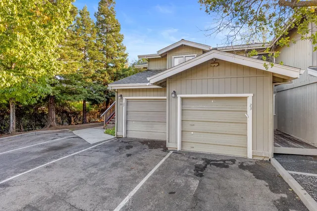 a view of a house with a yard and garage