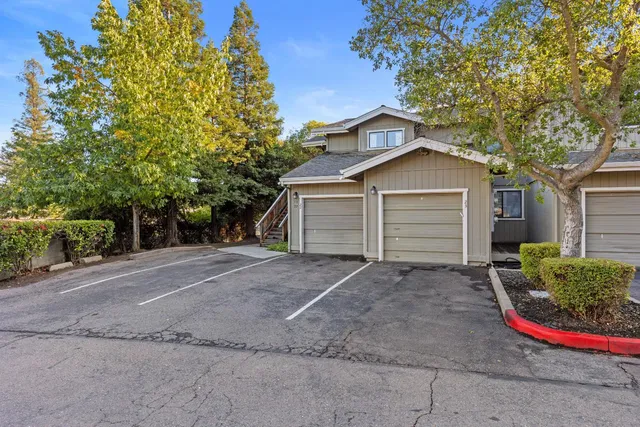 a view of a house with a yard and garage