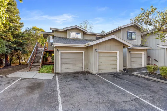 a view of a house with a yard and garage