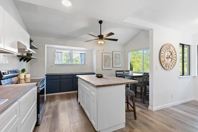 a kitchen with a stove cabinets and wooden floor