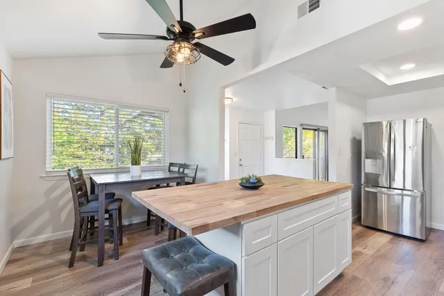 a kitchen with a table chairs and refrigerator
