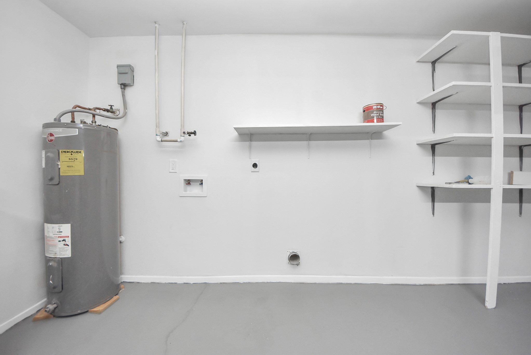 5314 Sweetwind Lane Spring, TX 77373 - Photo 39 of 47 Utility room featuring a water heater, ample shelving for storage, and washer/dryer hookups for convenience.