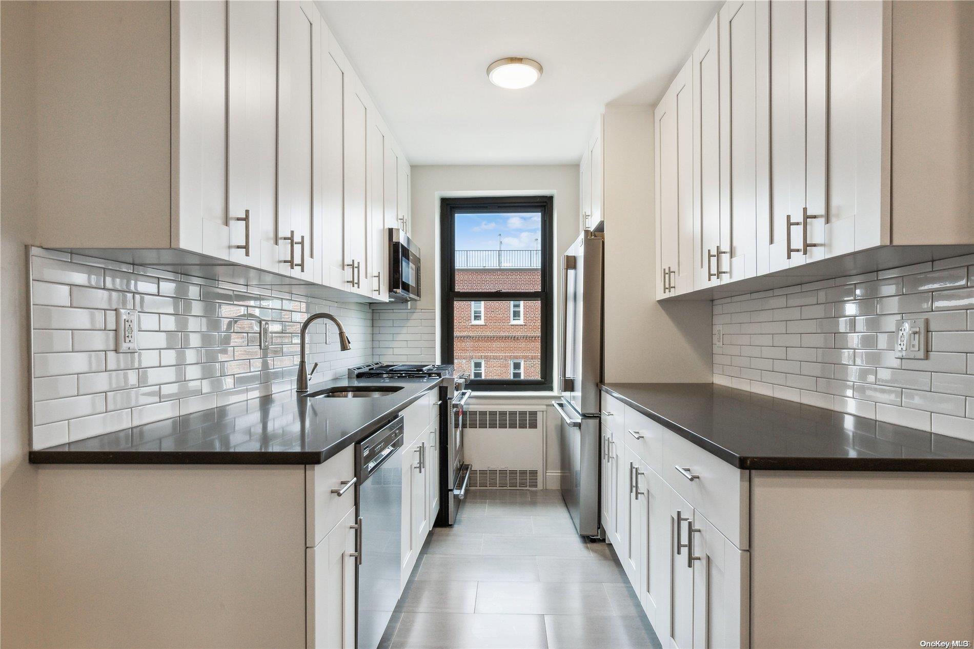 100-11 67th Road, Unit 605 Queens, NY 11375 - Photo 1 of 1 a kitchen with stainless steel appliances granite countertop a sink stove and cabinets