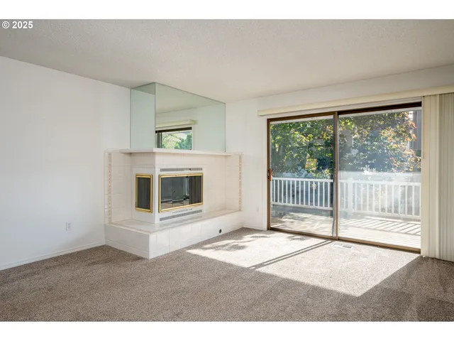 a bedroom with a balcony and a floor to ceiling window