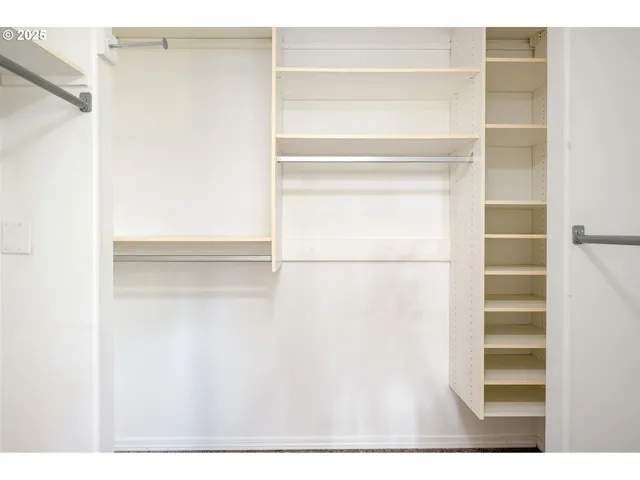 a view of an empty room with a fireplace and a window