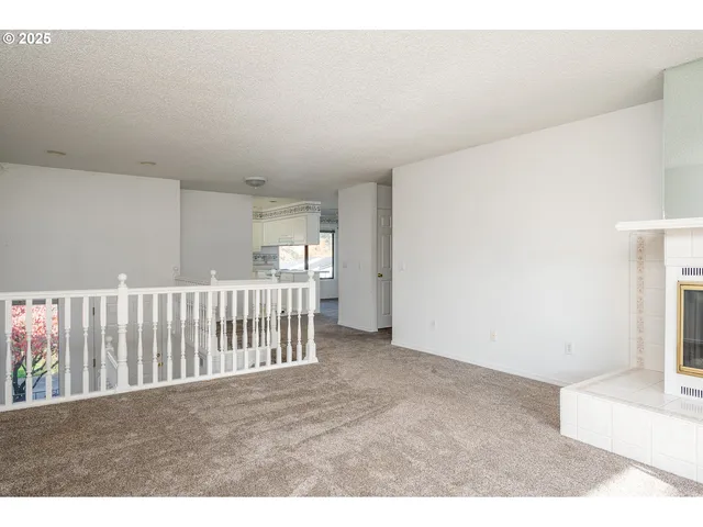 a view of an empty room with a fireplace