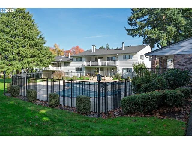 a view of a house with a yard and sitting area