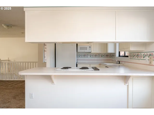 a kitchen with stainless steel appliances a sink and a stove