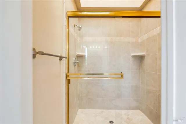 a bathroom with a glass shower door