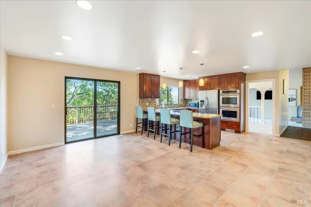 a view of a kitchen with dining room and windows