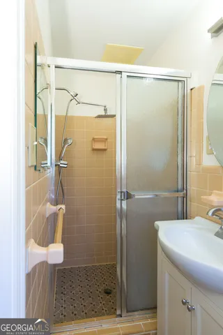 a bathroom with a shower and a sink