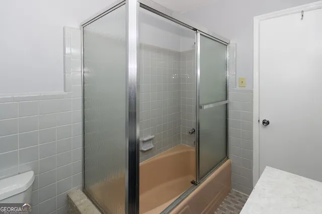 a bathroom with a glass shower door