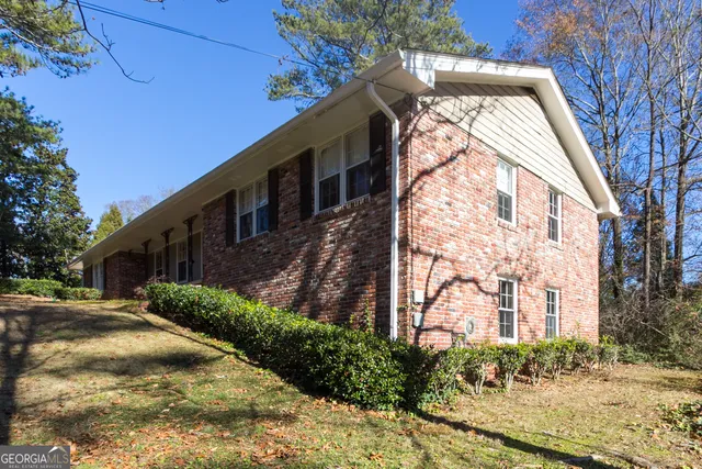 a view of a large brick building next to a yard