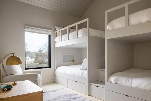 a bedroom with a large bed and a large window