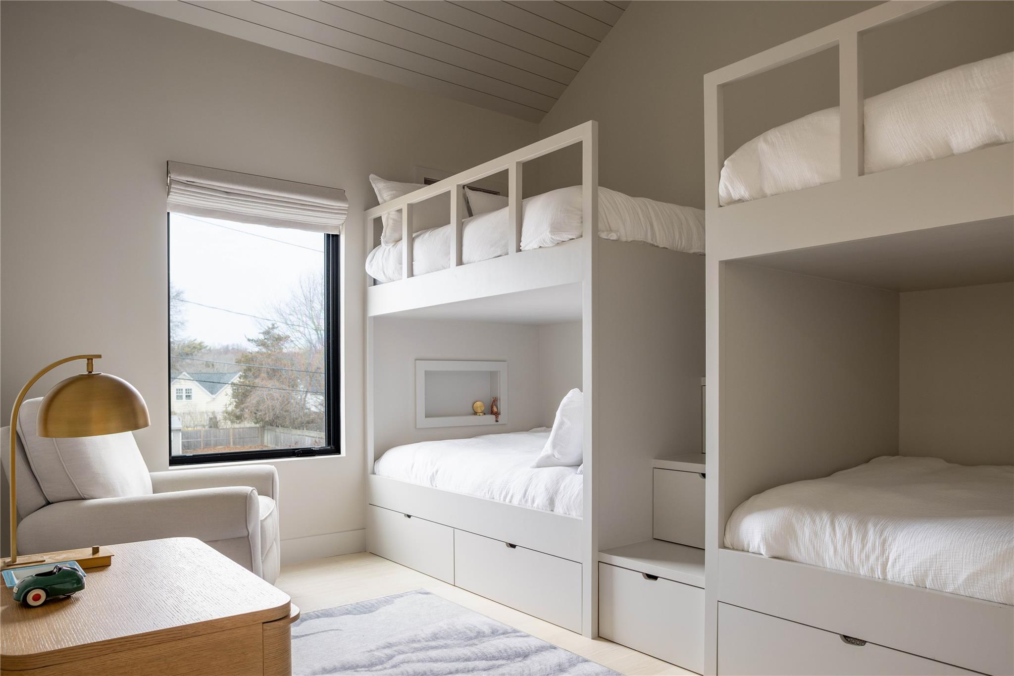61 Peconic Avenue Shelter Island Heights, NY 11964 - Photo 12 of 27 a bedroom with a large bed and a large window