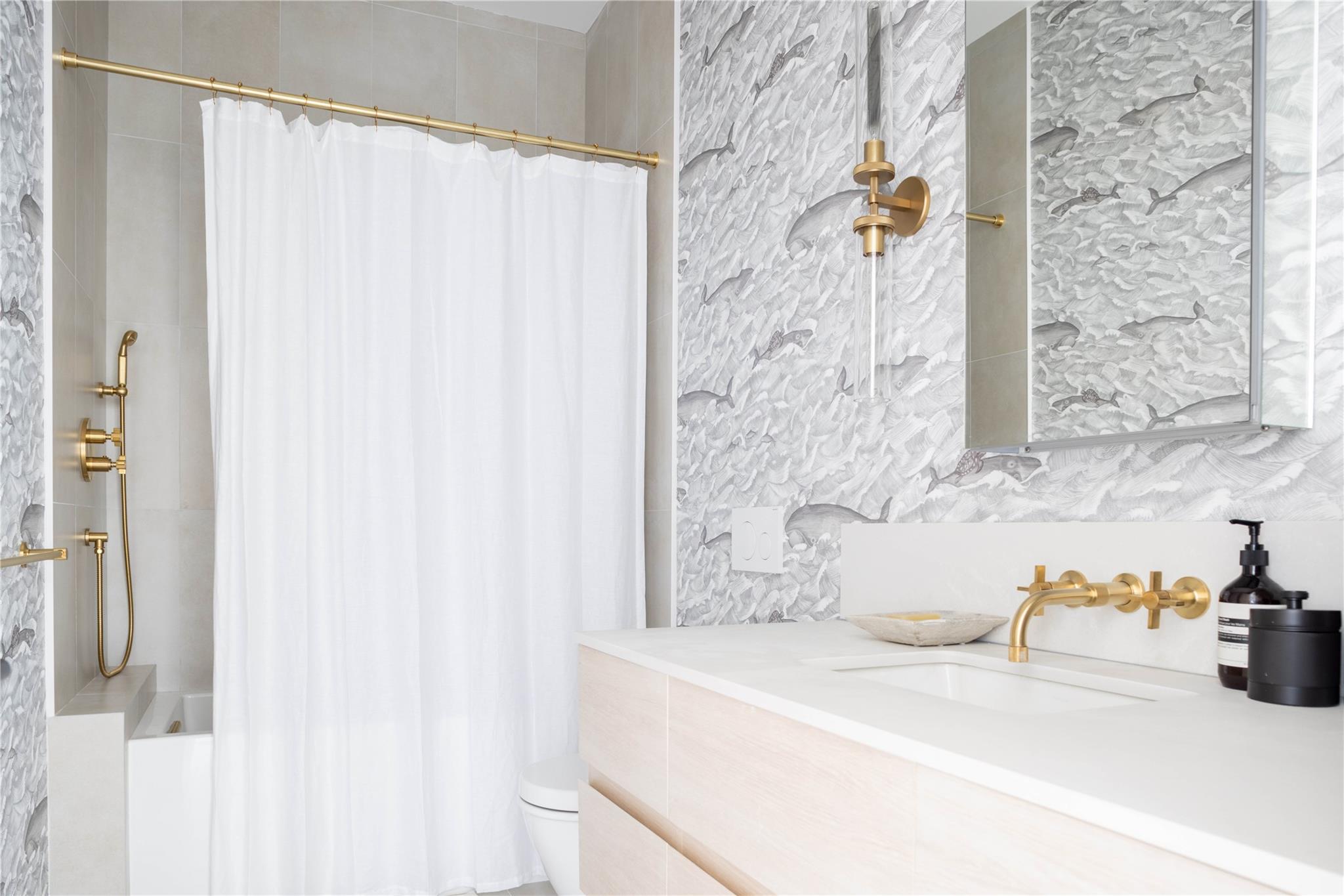 61 Peconic Avenue Shelter Island Heights, NY 11964 - Photo 16 of 27 a bathroom with a sink and a mirror