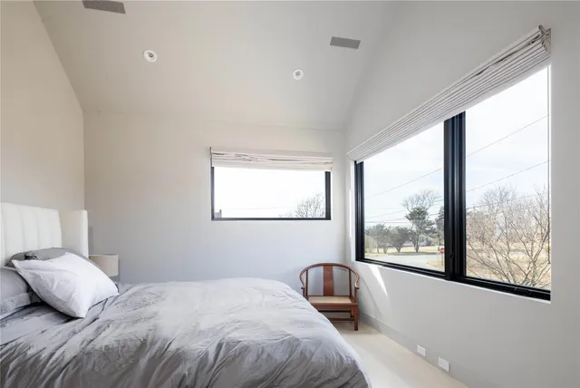 a bedroom with a large bed and a large window