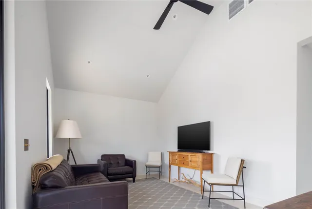 a living room with furniture and a lamp