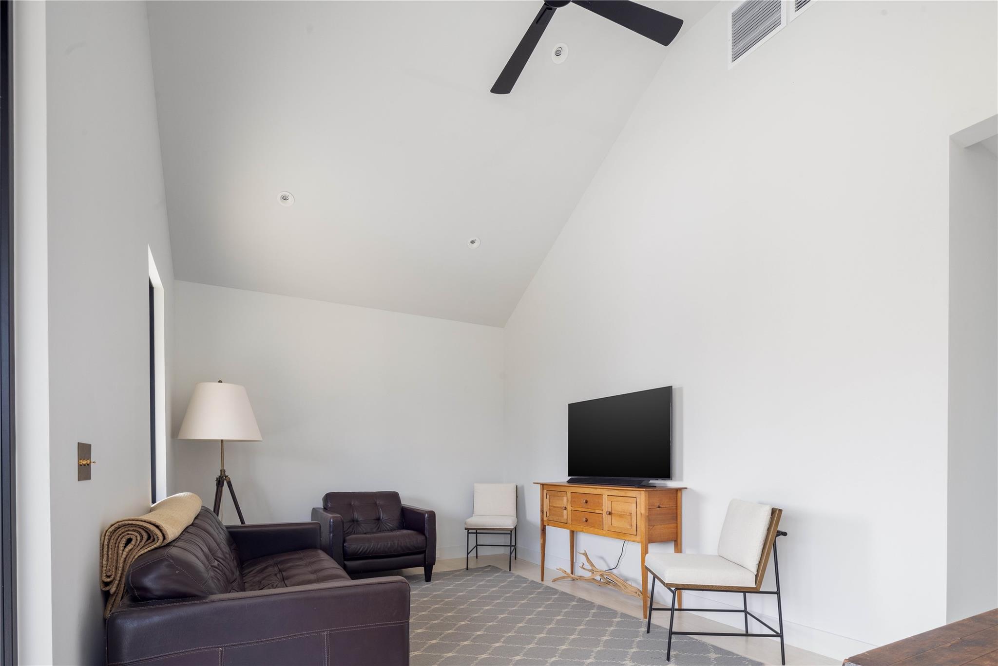 61 Peconic Avenue Shelter Island Heights, NY 11964 - Photo 20 of 27 a living room with furniture and a lamp