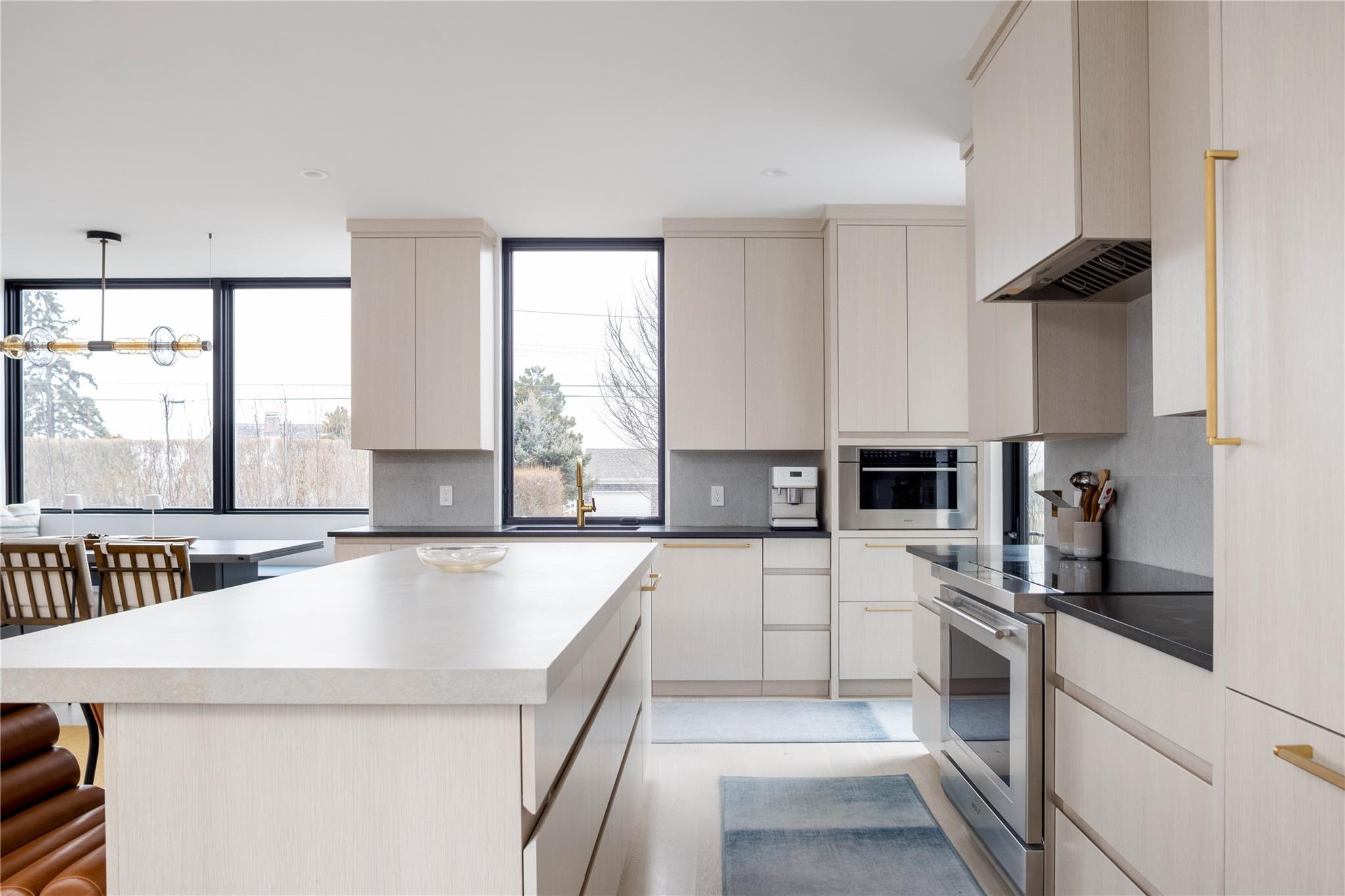 61 Peconic Avenue Shelter Island Heights, NY 11964 - Photo 2 of 27 a kitchen with a sink a stove top oven and white cabinets