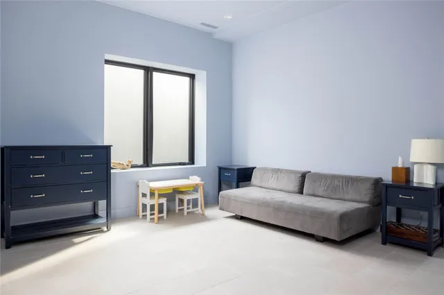 a living room with furniture and a lamp