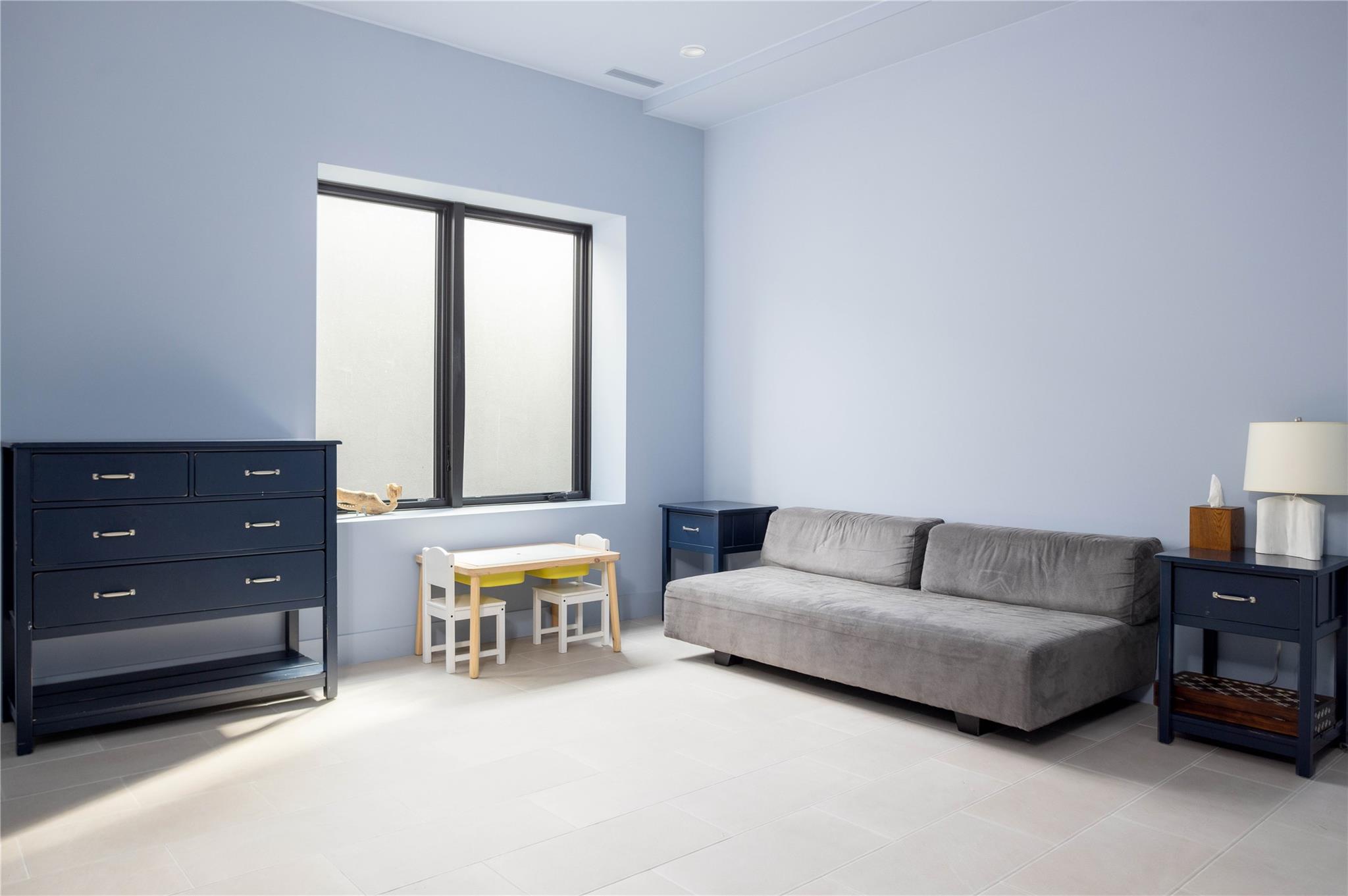 61 Peconic Avenue Shelter Island Heights, NY 11964 - Photo 22 of 27 a living room with furniture and a lamp