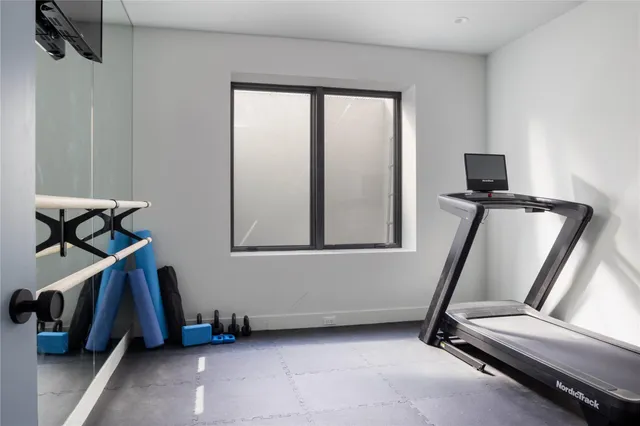 a room with gym equipment and windows