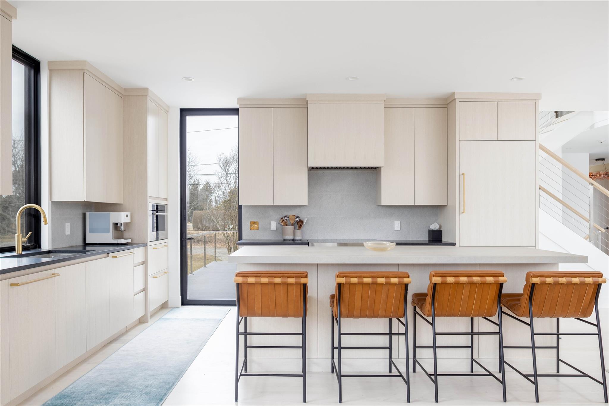 61 Peconic Avenue Shelter Island Heights, NY 11964 - Photo 3 of 27 a kitchen with stainless steel appliances granite countertop a stove a sink dishwasher and white cabinets with wooden floor