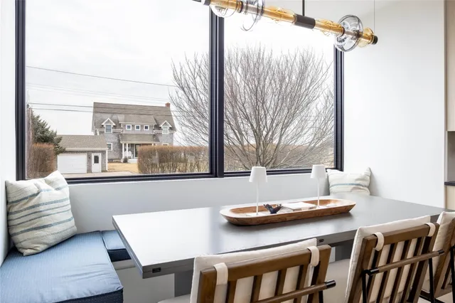 a view of a dining room with furniture and a window