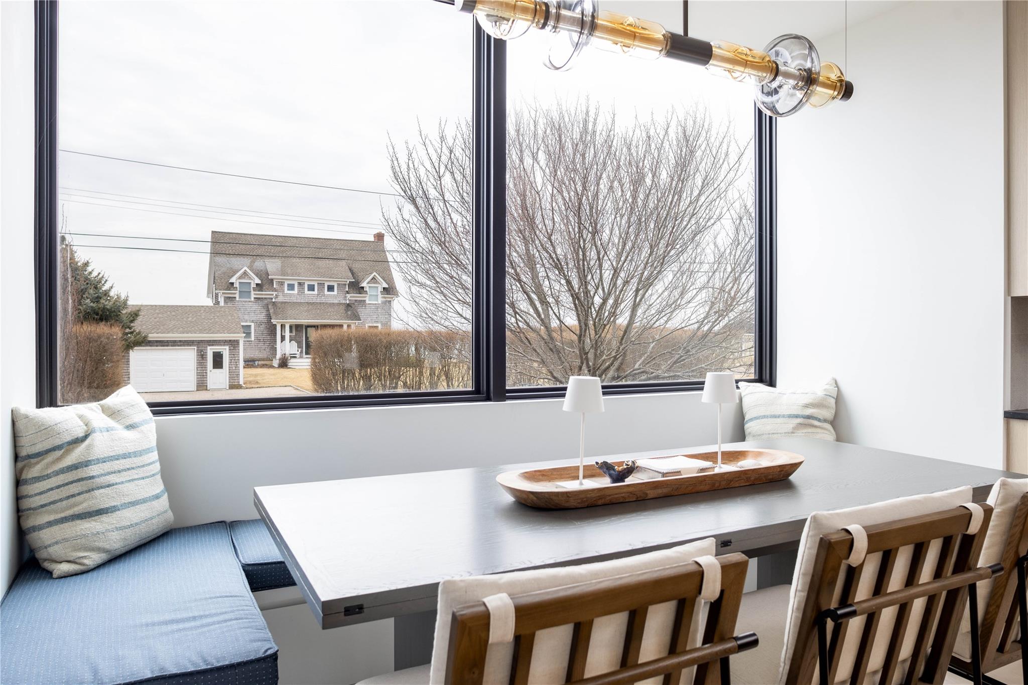 61 Peconic Avenue Shelter Island Heights, NY 11964 - Photo 4 of 27 a view of a dining room with furniture and a window
