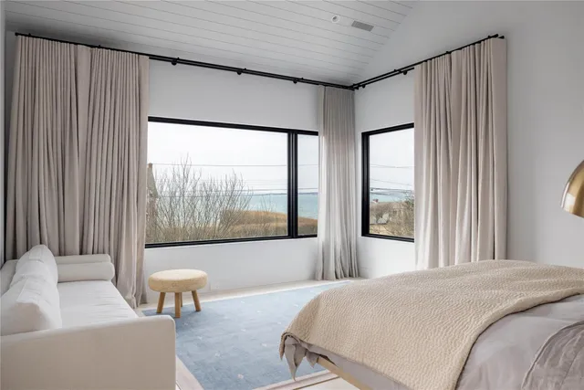 a bedroom with a large bed and a large window