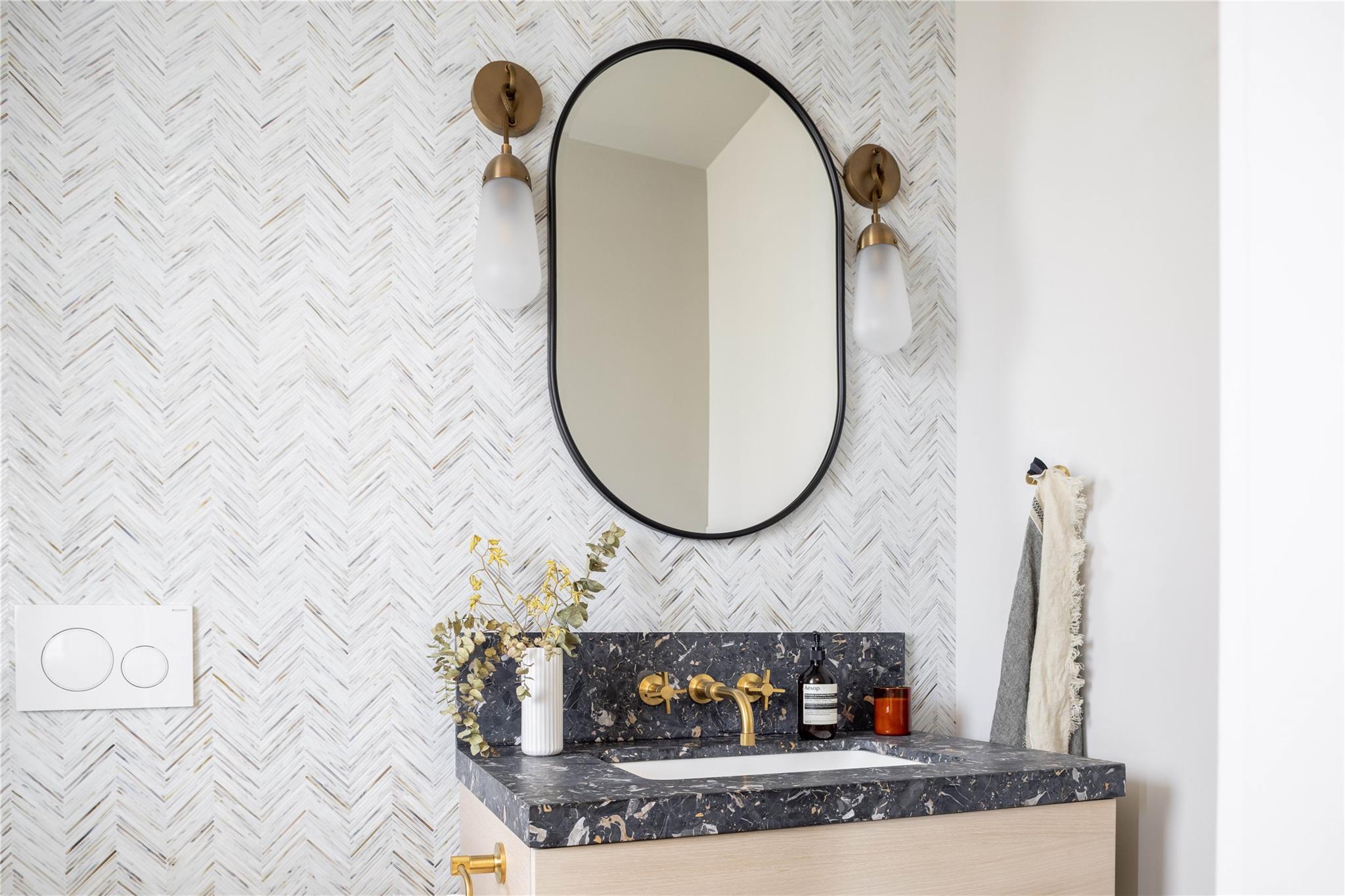 61 Peconic Avenue Shelter Island Heights, NY 11964 - Photo 10 of 27 a bathroom with a sink and a mirror