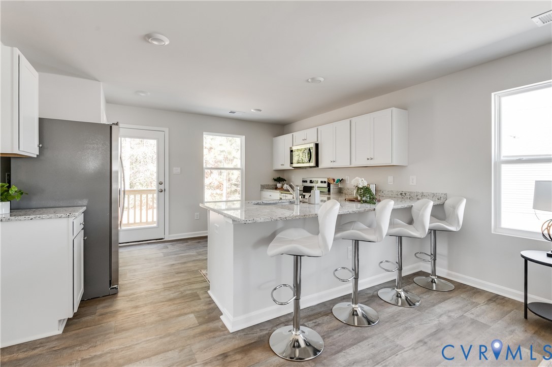 101 Our Way Drive Kilmarnock, VA 22482 - Photo 13 of 38 a view of kitchen with sink dining table and chairs