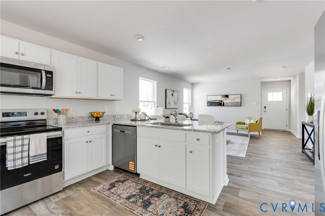 101 Our Way Drive Kilmarnock, VA 22482 - Photo 16 of 38 a kitchen with stainless steel appliances granite countertop a stove and white cabinets