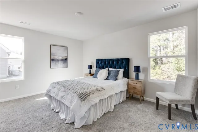 a bedroom with a bed chair and a window