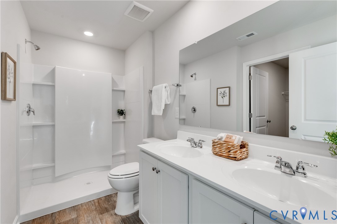 101 Our Way Drive Kilmarnock, VA 22482 - Photo 24 of 38 a bathroom with a granite countertop sink toilet and shower
