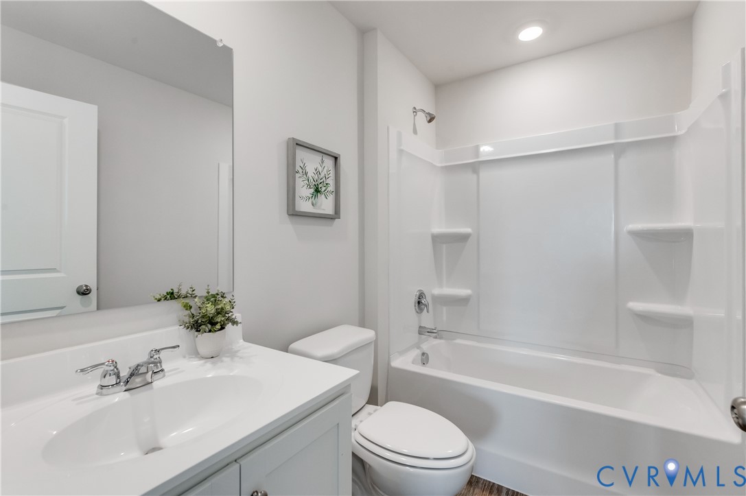 101 Our Way Drive Kilmarnock, VA 22482 - Photo 28 of 38 a bathroom with a bathtub shower sink vanity mirror and toilet