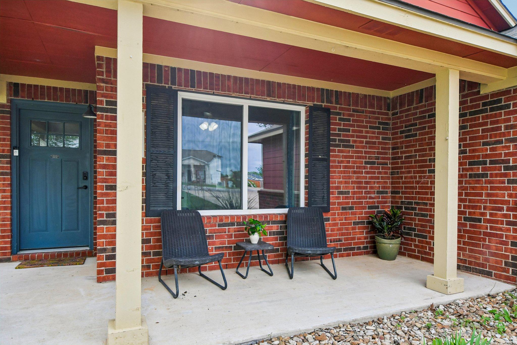 125 Mason Reed Cove Kyle, TX 78640 - Photo 4 of 39 a view of a brick building with a bench in front of building