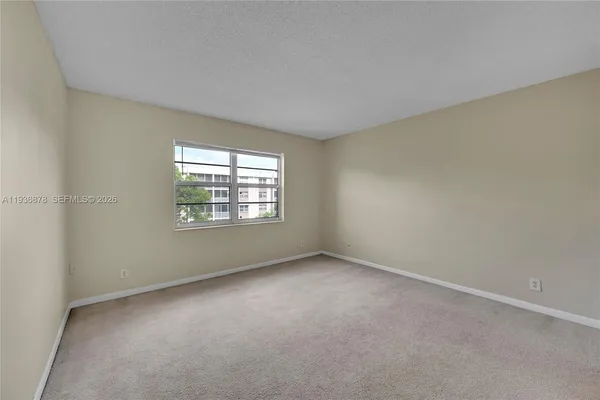 a view of an empty room and closet area