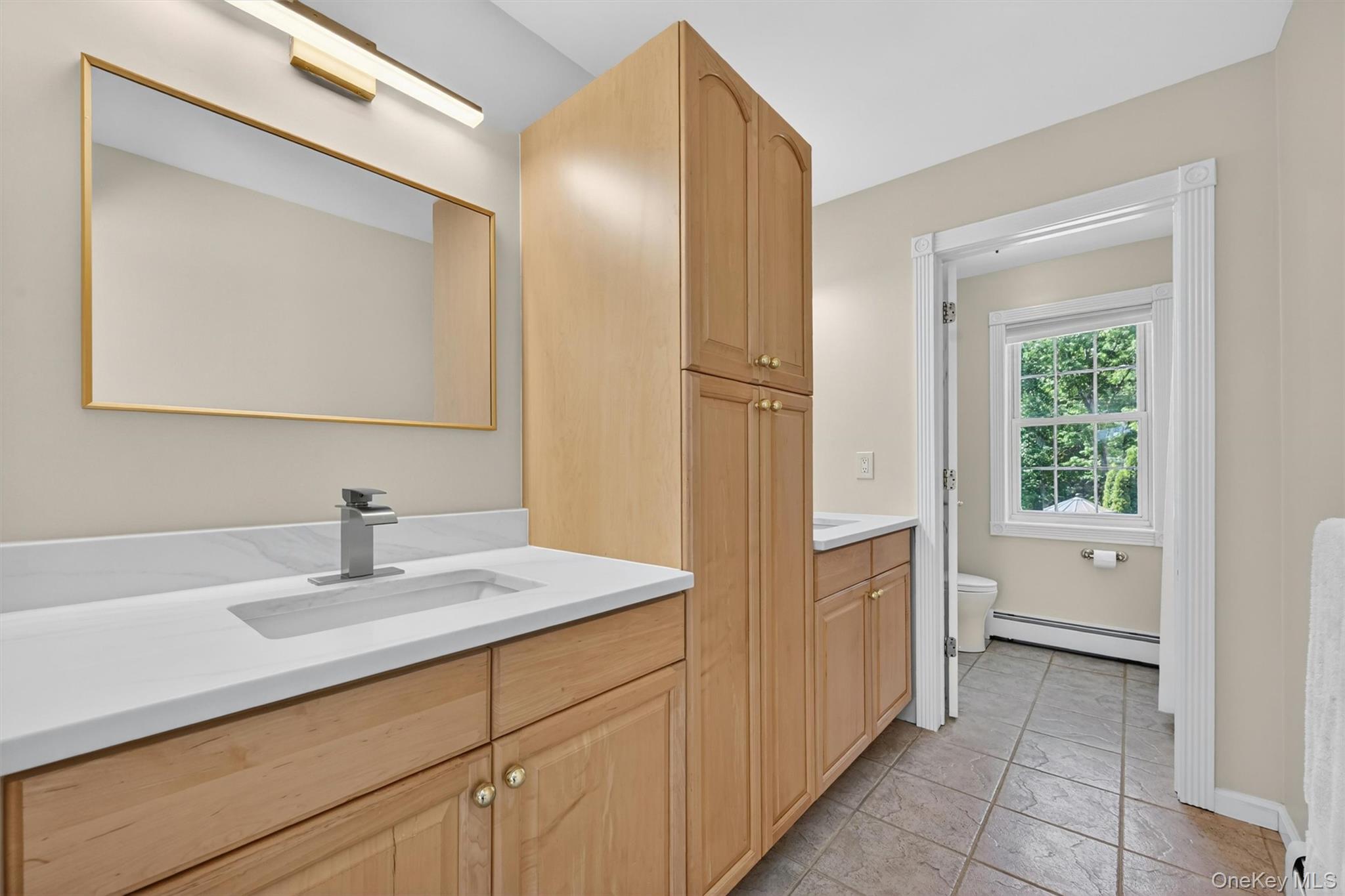 954 Ridgebury Road New Hampton, NY 10958 - Photo 31 of 45 The second-floor ensuite bath is designed with everyday comfort in mind, offering dual sinks, generous linen storage, and a calm, functional layout that keeps everything within easy reach.