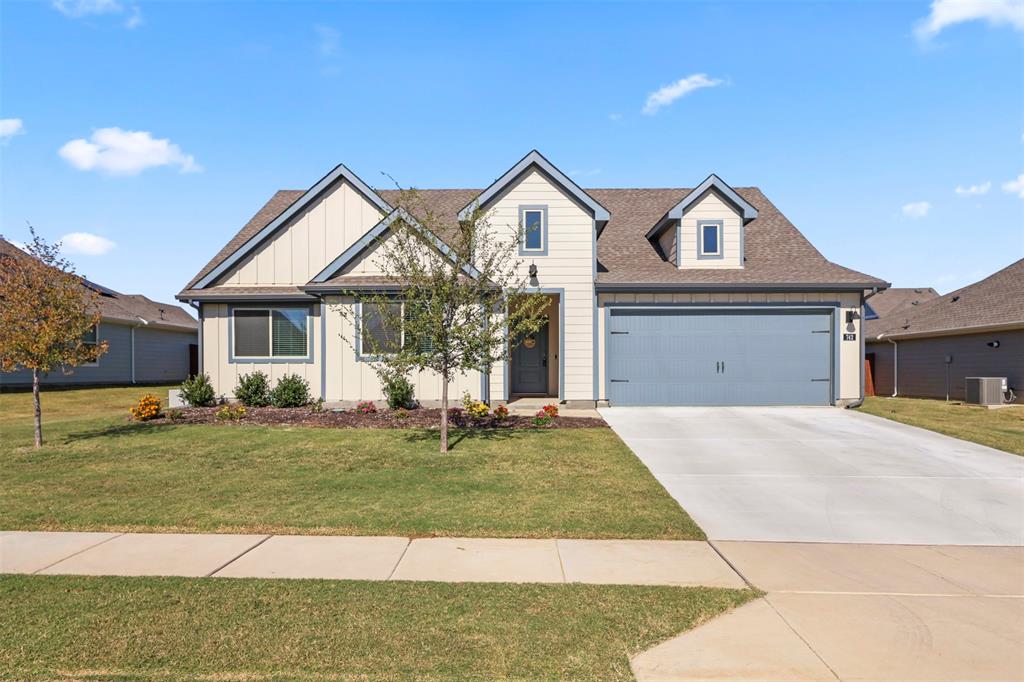 742 Buttercup Drive Pilot Point, TX 76258 - Photo 2 of 20 View of front of property with a front lawn, driveway, roof with shingles, and board and batten siding