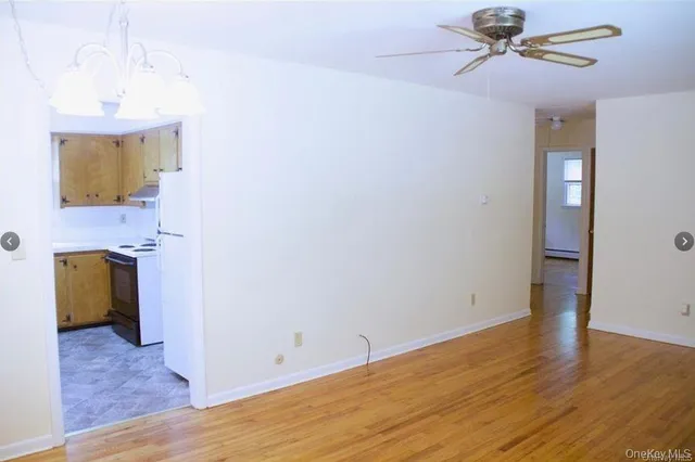 a view of hallway with wooden floor