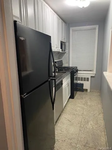 a kitchen with a refrigerator and a sink