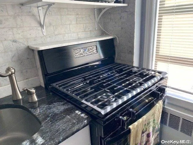 a stove sitting inside of a kitchen